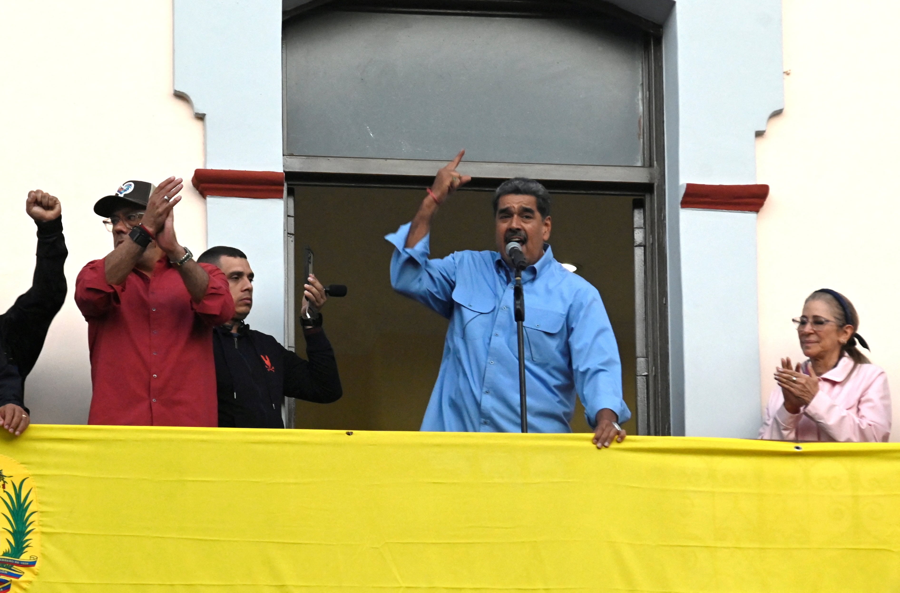 Venezuelan President Nicolas Maduro talks to supporters from a balcony at Miraflores Palace after the presidential election, in Caracas, Venezuela July 30, 2024. REUTERS/Maxwell Briceno