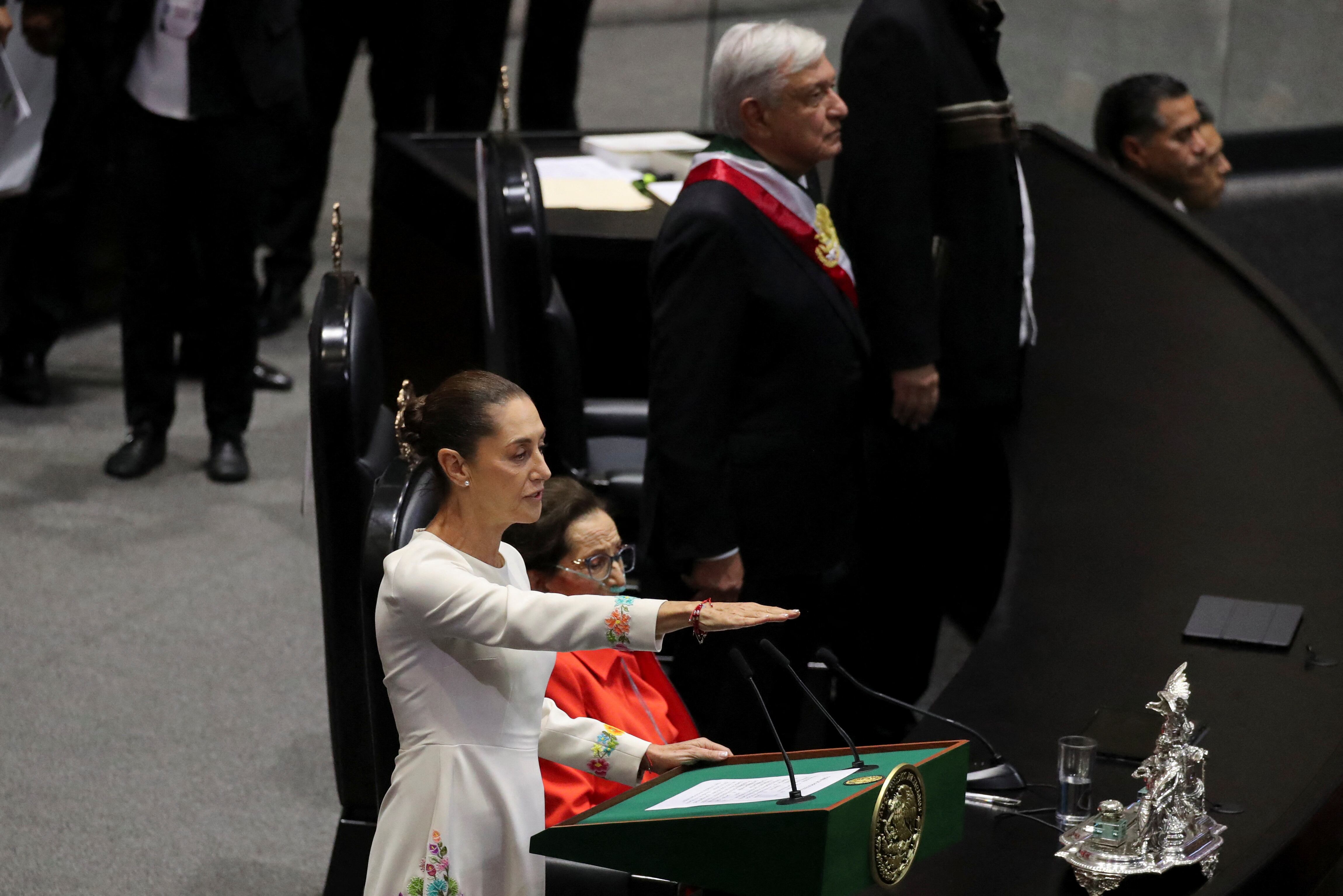 Claudia Sheinbaum swears in as Mexico's new President as Andres Manuel Lopez Obrador is seen in the background at the Congress, in Mexico City, Mexico, October 1, 2024. REUTERS/Henry Romero