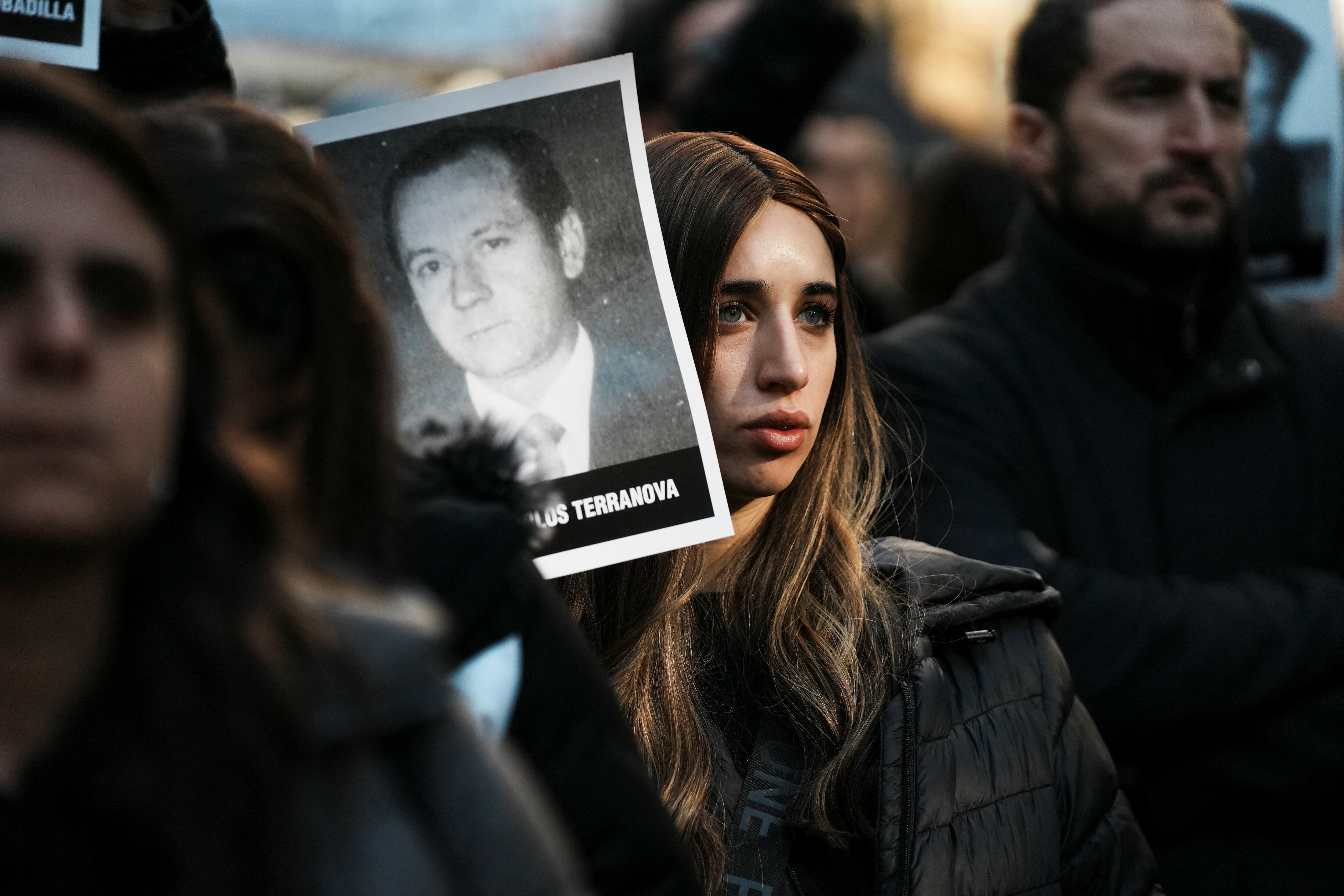 A woman holds an image of a victim of the 1994 bombing attack on the Argentine Israeli Mutual Association (AMIA) community centre, marking the 30th anniversary of the attack, in Buenos Aires, Argentina July 18, 2024. REUTERS/Irina Dambrauskas