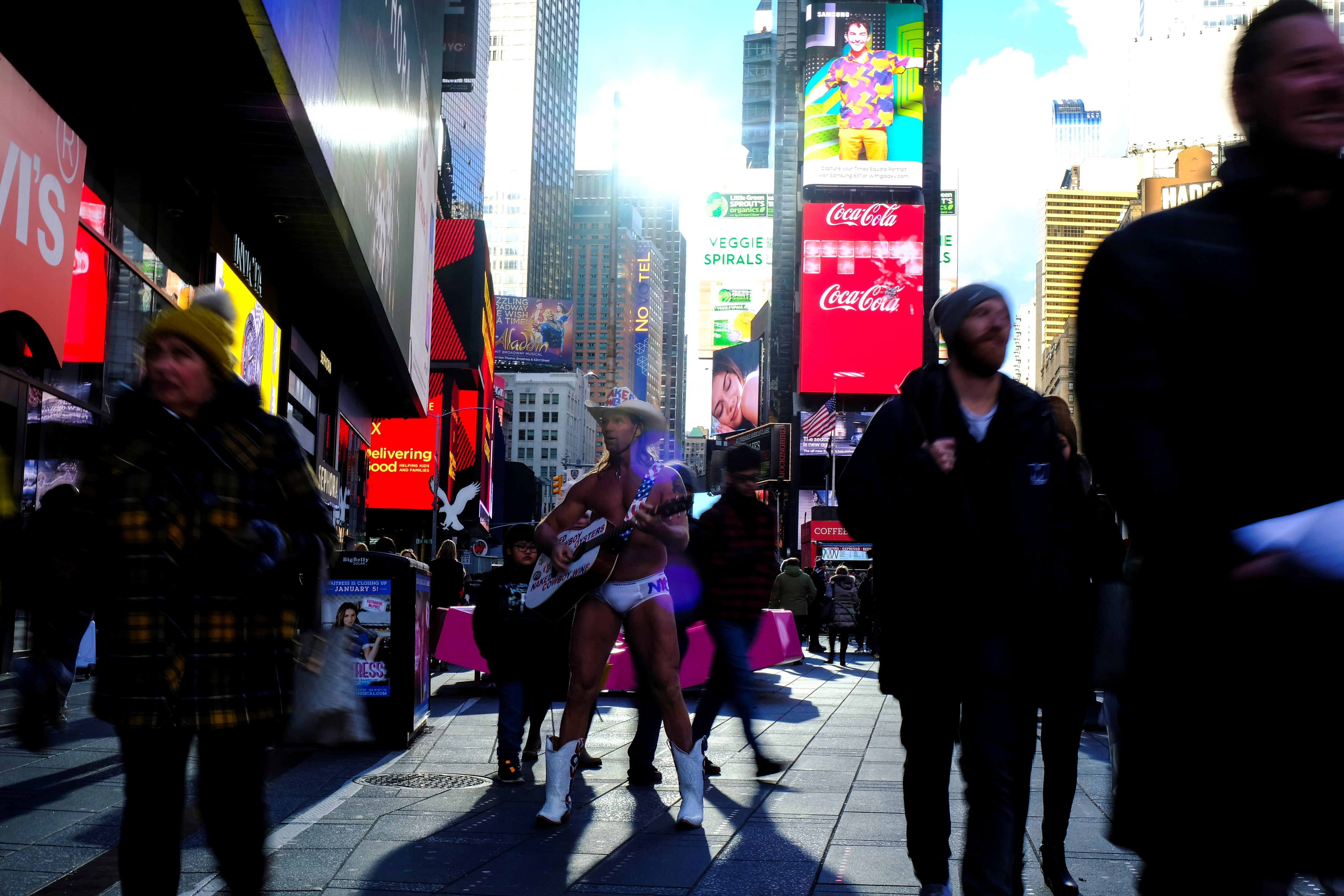 Robert Burke also known as Naked Cowboy entertains tourists in Time Square on a cold day in New York City, U.S., December 05, 2019.  REUTERS/Maria Alejandra Cardona