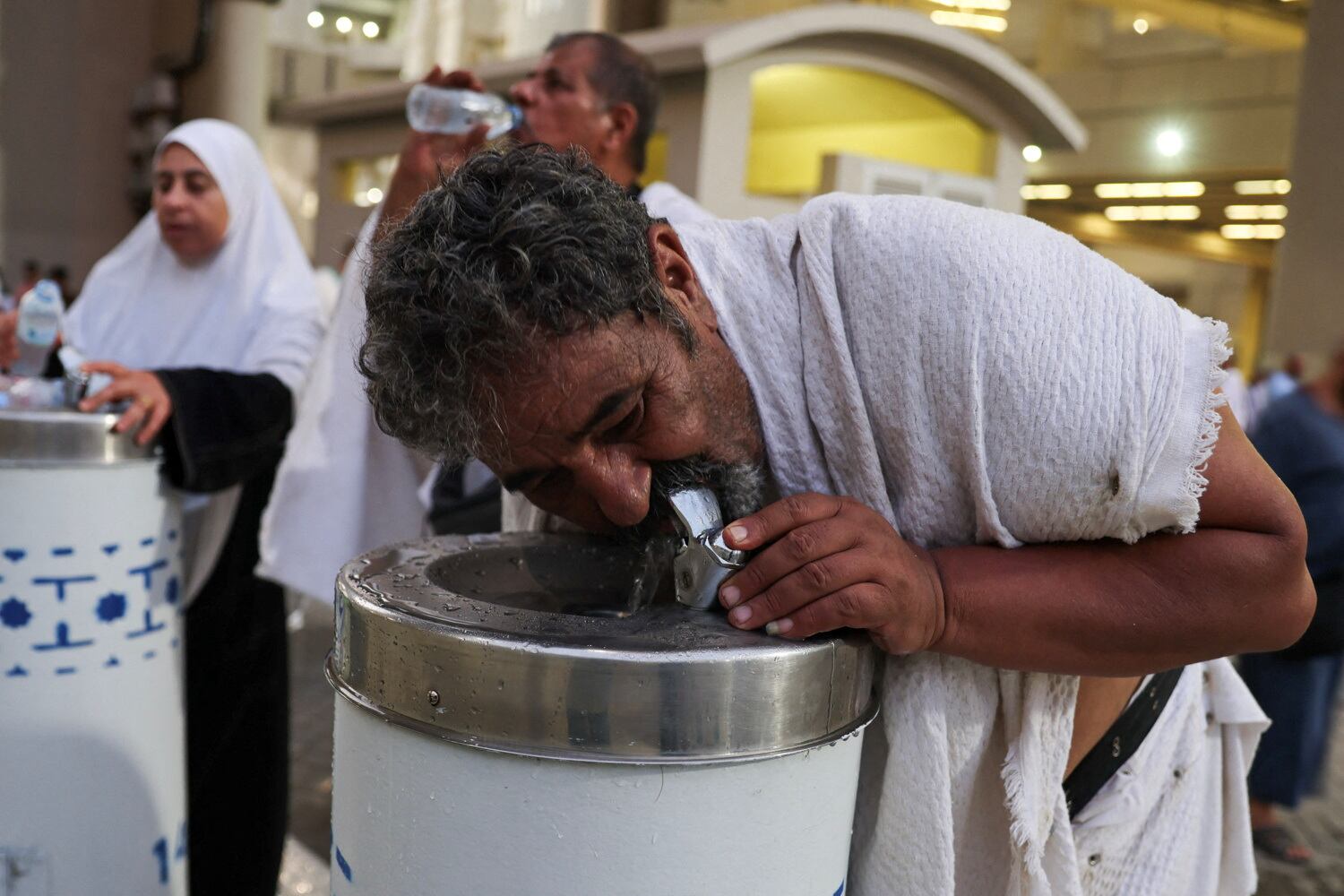 Los peregrinos musulmanes beben agua durante un clima extremadamente caluroso, el primer día del ritual de lapidación de Satanás, durante la peregrinación anual haj, en Mina, Arabia Saudita (REUTERS/Saleh Salem)
