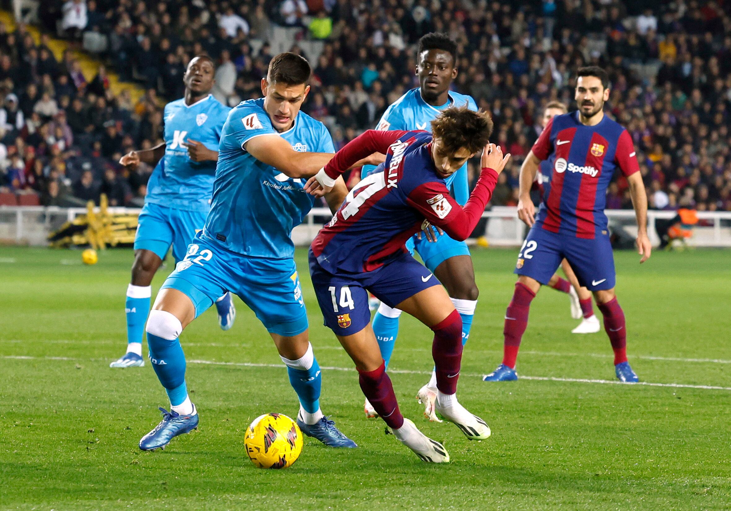 Soccer Football - LaLiga - FC Barcelona v Almeria - Estadi Olimpic Lluis Companys, Barcelona, Spain - December 20, 2023 FC Barcelona's Joao Felix in action with Almeria's Cesar Montes and Iddrisu Baba Mohammed REUTERS/Albert Gea