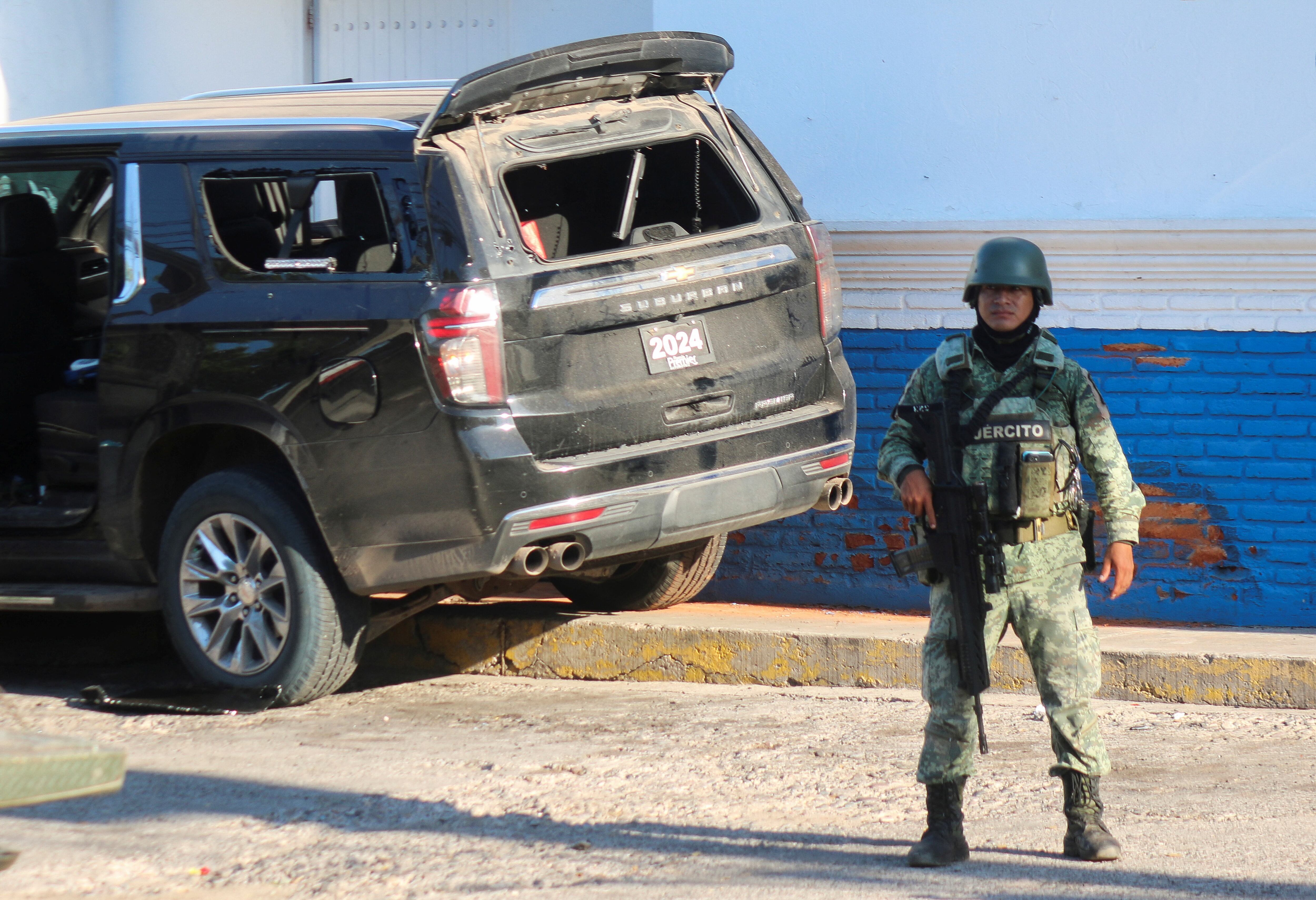 Miembro del ejército mexicano hace guardia en el lugar de un automóvil dañado tras un enfrentamiento entre grupos armados en Culiacán
(Foto: REUTERS/Jesus Bustamante)