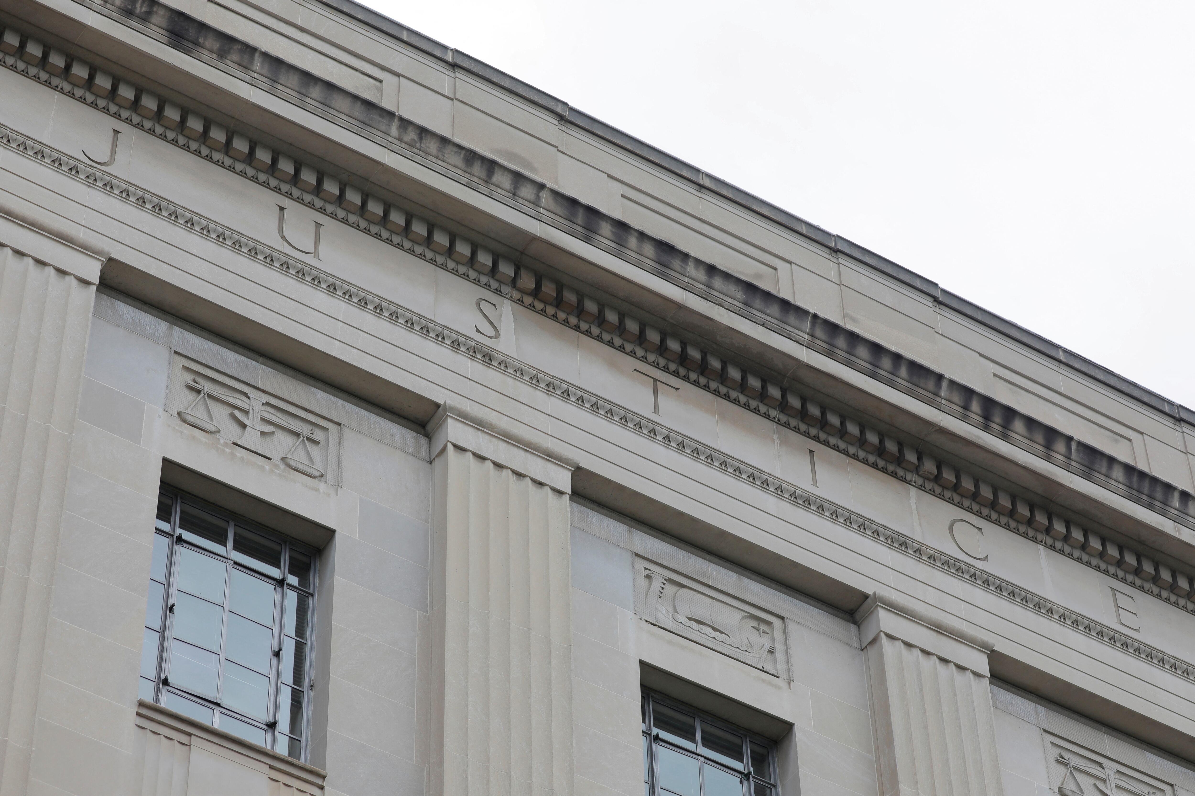 FILE PHOTO: The word "justice" is seen engraved at the headquarters of the United States Department of Justice (DOJ) in Washington, D.C., U.S., May 10, 2021. REUTERS/Andrew Kelly/File Photo